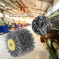 Abrasive wire wheel brush with yellow mounting hub and gray bristle cluster