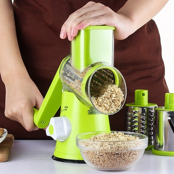 Green electric slicer with clear chute dispensing chopped ingredients into a bowl