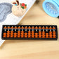 Plastic 15-digit abacus toy showing orange and dark beads on white rods, black tray