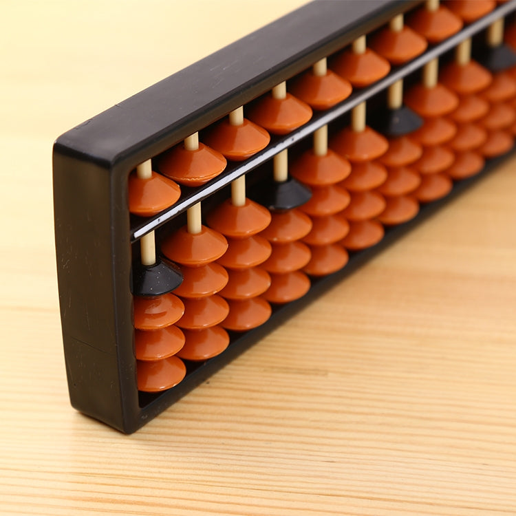 Plastic abacus close-up: orange and dark beads on white rods inside black frame