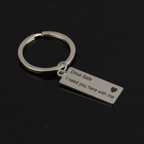 Silver engraved keyring with rectangular tag reading “Drive Safe I need you here with me”