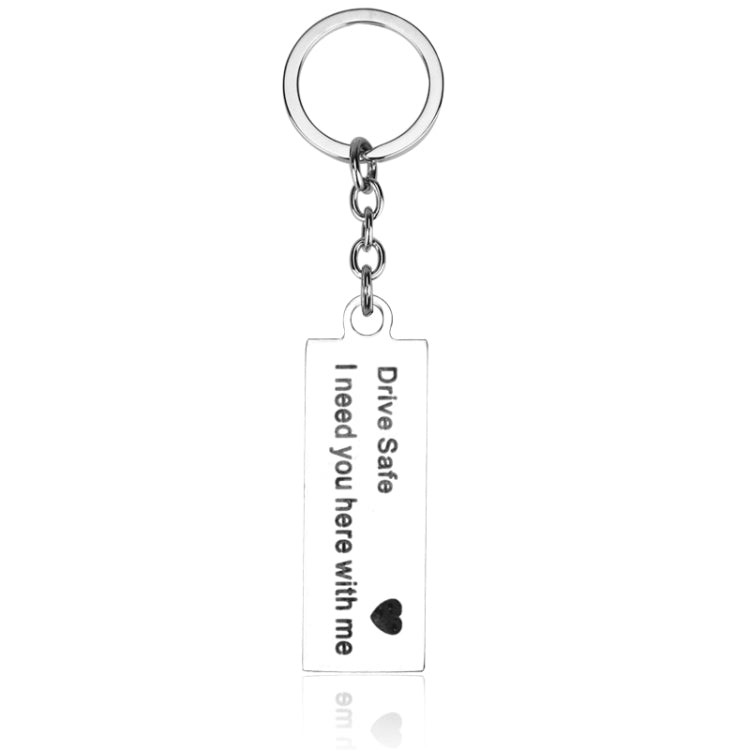 Silver keyring with chain and rectangular tag engraved “Drive Safe I need you here with me”