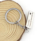 Silver keyring with engraved rectangular tag reading “Drive Safe I need you here with me”