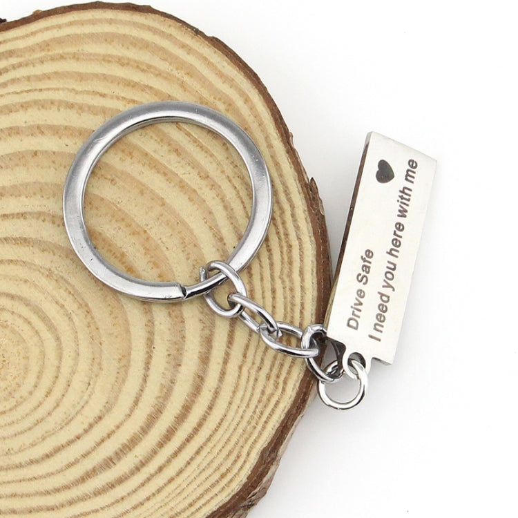 Silver keyring with engraved rectangular tag reading “Drive Safe I need you here with me”