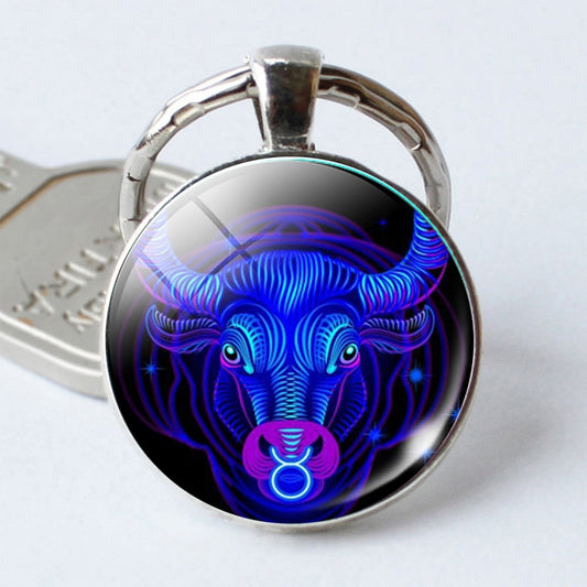 Silver-tone keychain with round pendant featuring a blue glowing bull portrait, single-sided.