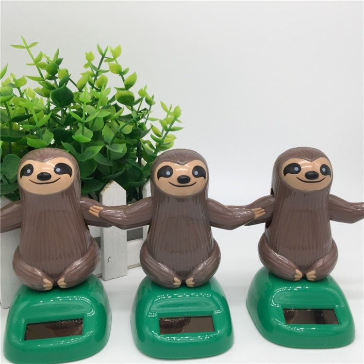Solar-powered dancing sloth toy set: three brown sloth figures on green solar bases