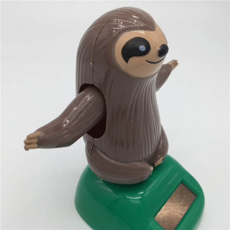 Solar-powered dancing sloth figure on green base, side view with arms raised