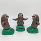 Solar-powered dancing sloth toy set: three brown sloth figures on green solar bases