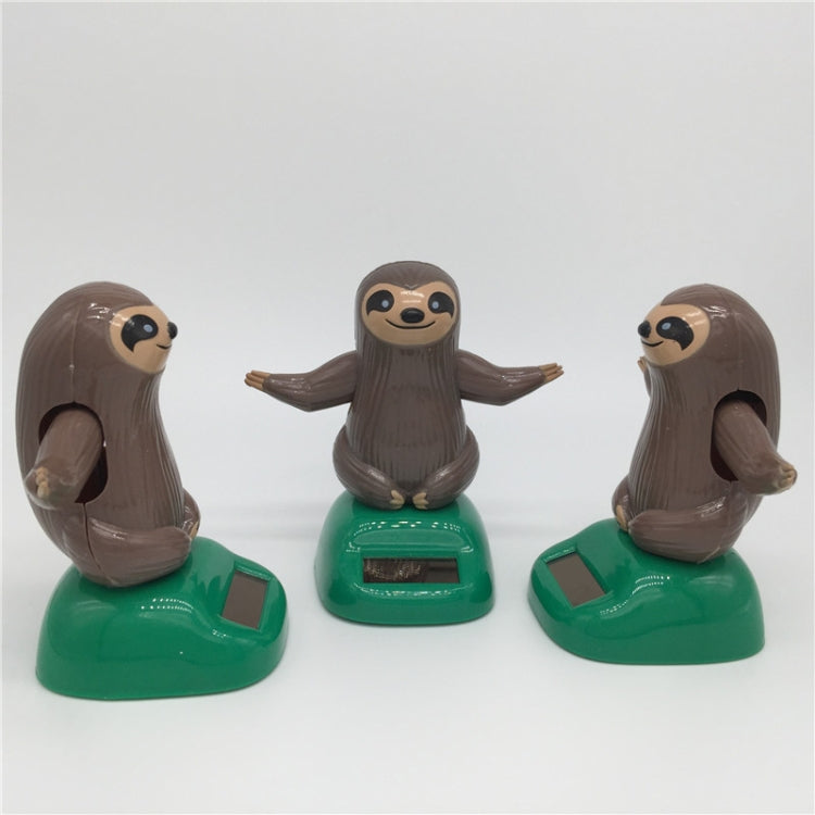 Solar-powered dancing sloth toy set: three brown sloth figures on green solar bases