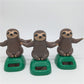 Solar-powered dancing sloth toy set: three brown sloth figures on green solar bases