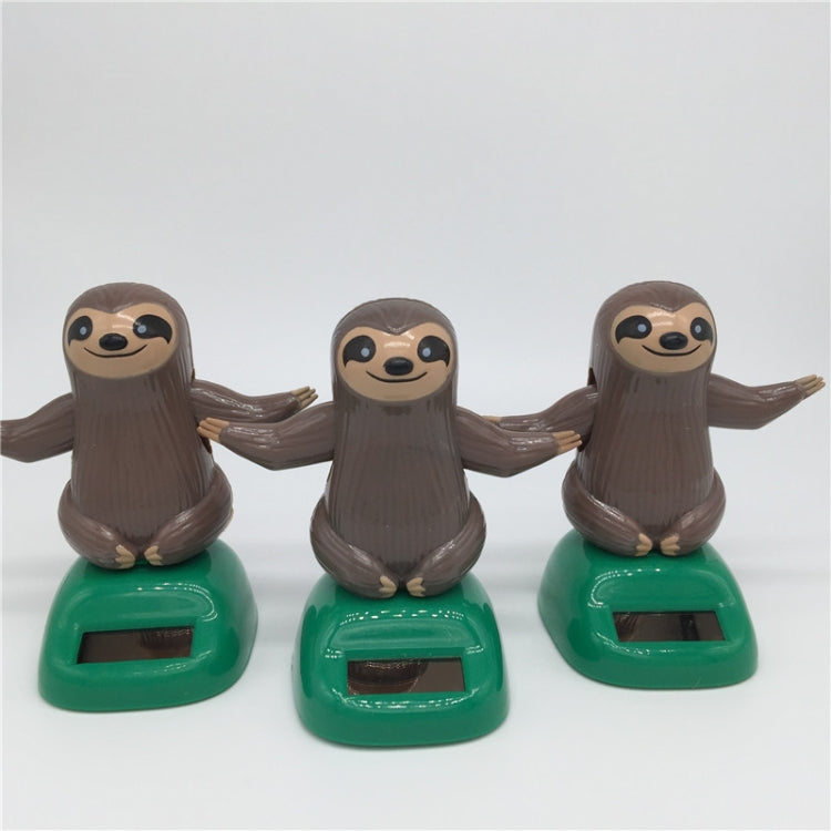 Solar-powered dancing sloth toy set: three brown sloth figures on green solar bases