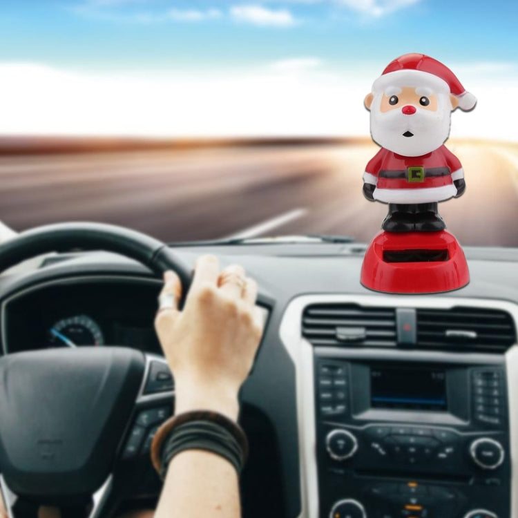 Red Santa Claus solar dashboard decoration with white beard and black boots on base