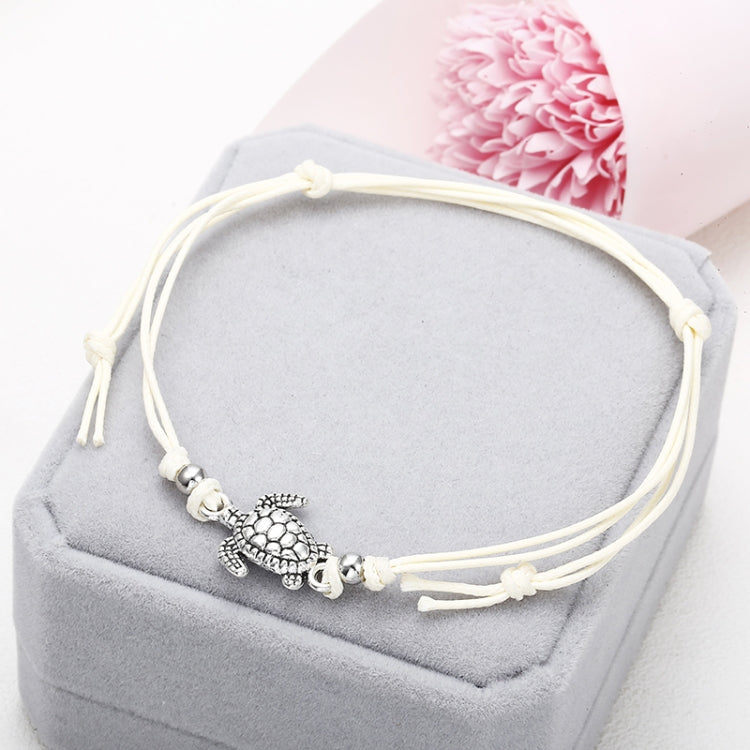 White wax string anklet with sea turtle charm and small round bead accents