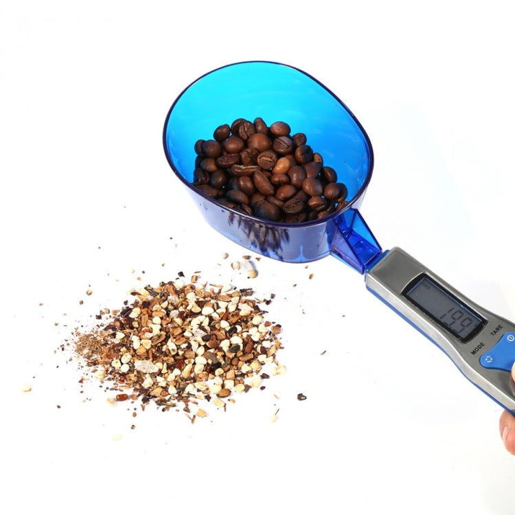 Digital spoon scale with coffee beans in blue scoop and LCD weight screen