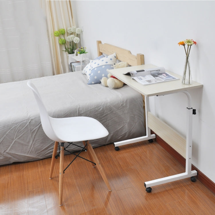 Bedside laptop desk with light wood top, white frame, storage shelf, and rolling casters