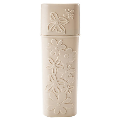 Beige carved travel toothbrush holder with flip-top cover and flower pattern