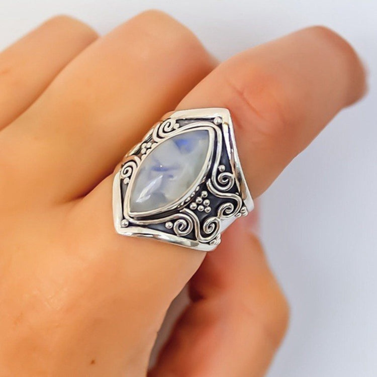 Silver filigree oval gemstone ring on hand