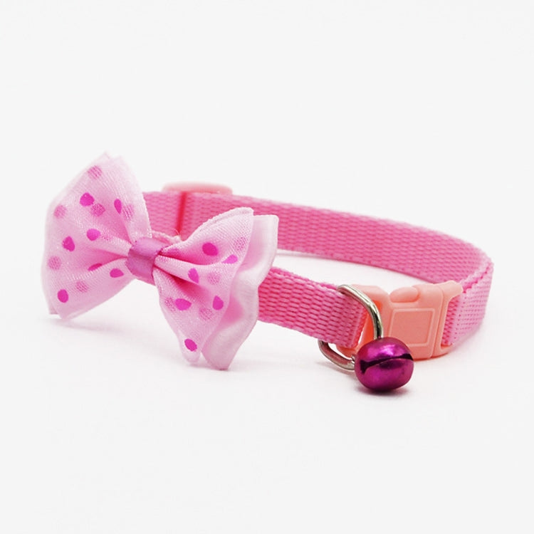 Adjustable pet bell collar with pink fabric bow and purple bell charm