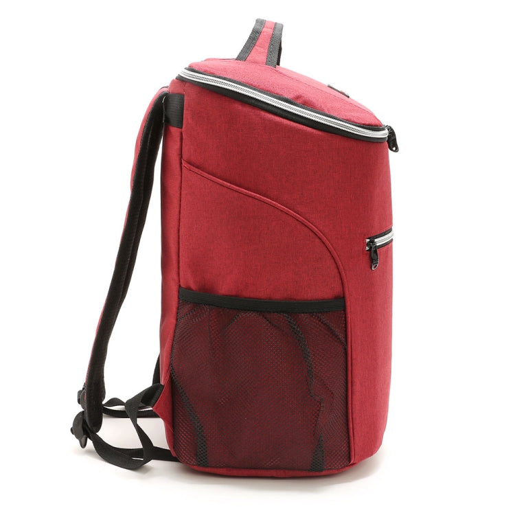 Red insulated cooler backpack with top handle and mesh front pocket