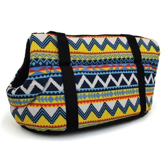 Pet carrying backpack with blue, yellow, and red zigzag fabric and black shoulder straps