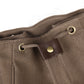 Tan canvas backpack side pocket with metal grommets and leather pull tab