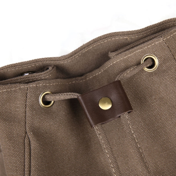 Tan canvas backpack side pocket with metal grommets and leather pull tab