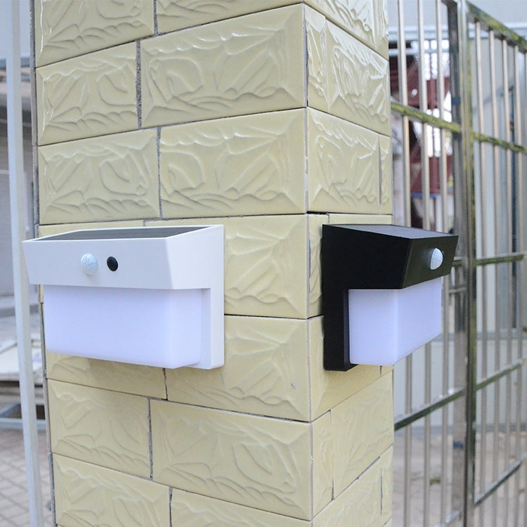 Solar wall lights shown in white and black, each with solar panel and sensor