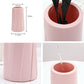 Pink plastic vase, 20cm tall and 9.5cm wide; fluted sides and round opening
