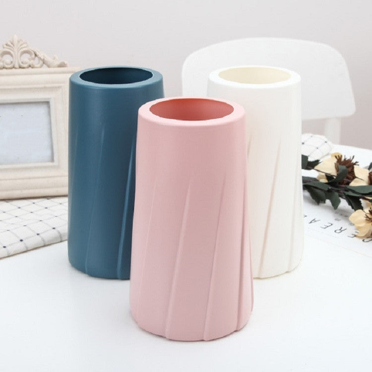 Set of three plastic vases: blue, pink, and milk white; fluted rounded bodies
