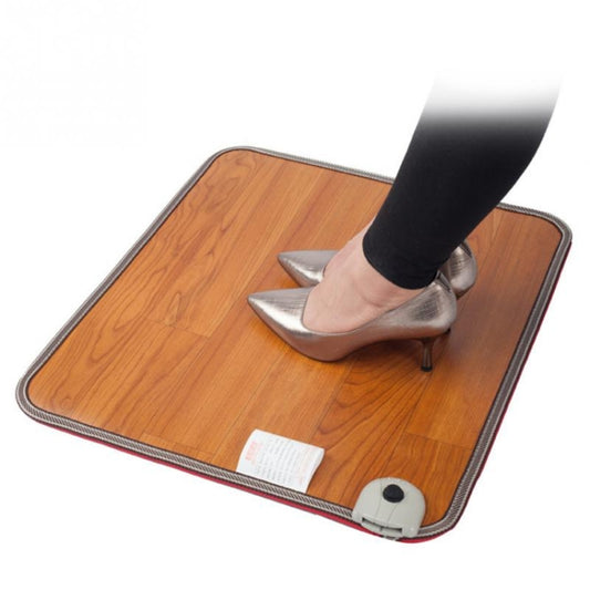 Heated foot mat with wood surface and edge trim, with shoes standing on it