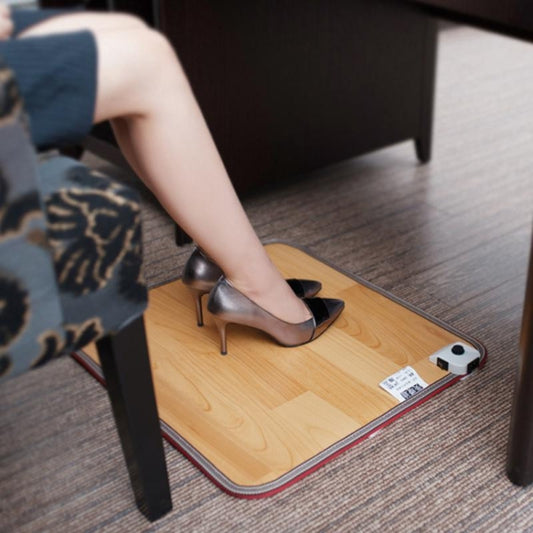 Electric foot heating mat with control box, under high heels on a floor