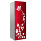 White floral bird refrigerator sticker with leaves and blossoms on a red three-door fridge.