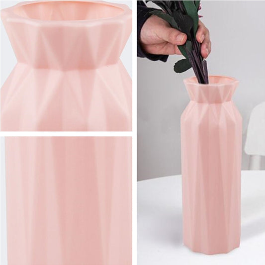 Pink plastic round vase with faceted sides and wide flared opening