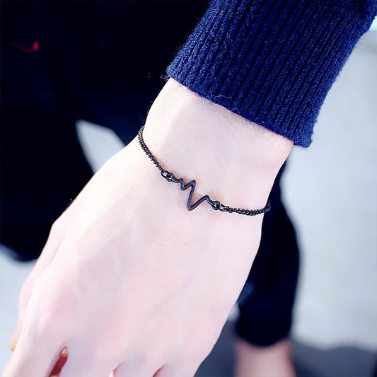 ECG waveform bracelet on wrist with black chain and zigzag lightning charm
