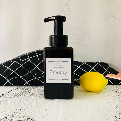 Square foam press bottle with black pump, brown/amber bottle, labeled One day
