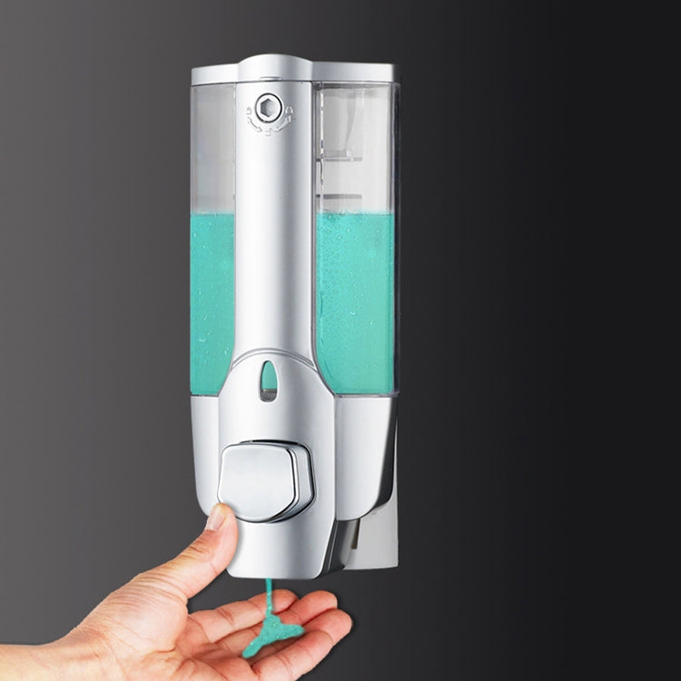 Wall-mounted manual soap dispenser, matte silver with teal liquid, see-through container