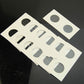Coin protector card sheets laid out, multiple white squares with round cutouts