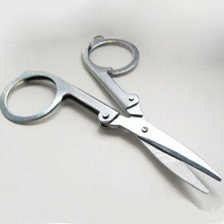 Folding scissors with oval finger rings and pointed blades, silver metal frame