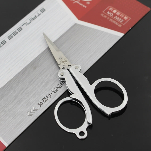 Mini folding scissors with finger rings and pointed blades, silver metal