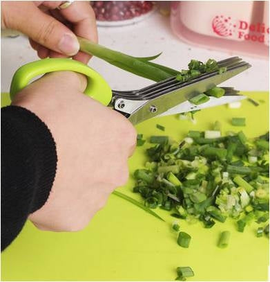 Green herb scissor shredder cutting green onions into small pieces