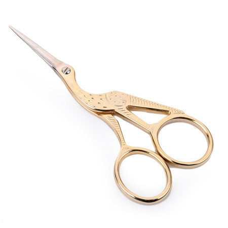 Gold-tone cross-stitch sewing scissors with pointed blades and decorative finger loops
