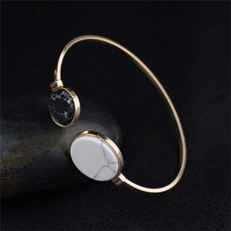 Gold-tone circular cuff bangle set with black and white faux stone round inlays