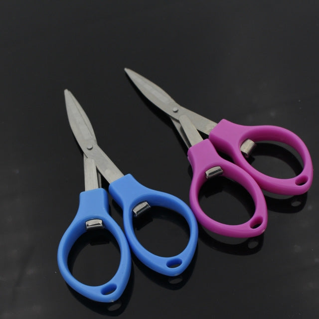 Foldable mini scissors with stainless blades and blue handles, compact pocket size