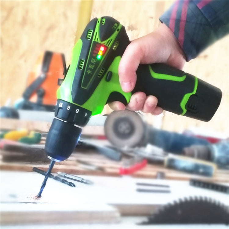 Hand using green and black cordless screwdriver to drive a screw