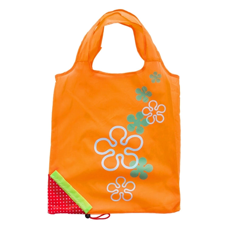 Reusable folding grocery bag in orange with colorful flower print and corner pocket