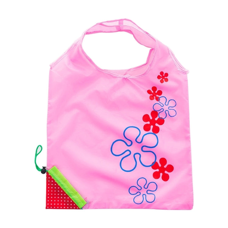 Reusable folding grocery bag in pink with colorful flower print and corner pocket