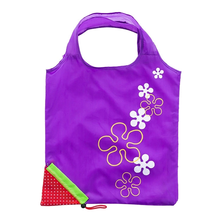 Reusable folding grocery bag in purple with colorful flower print and corner pocket