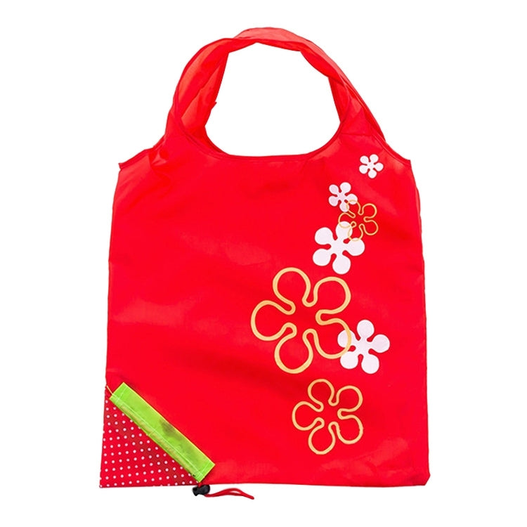 Reusable folding grocery bag in red with colorful flower print and corner pocket