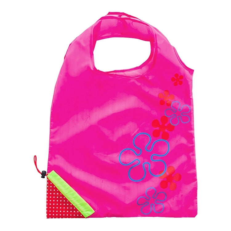 Reusable folding grocery bag in magenta pink with colorful flower print and corner pocket