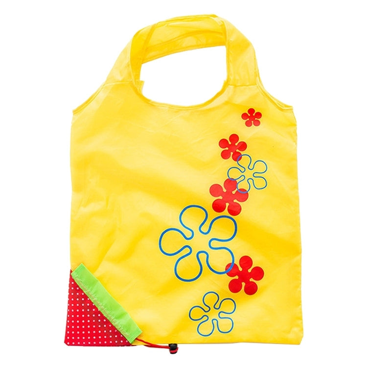 Reusable folding grocery bag in yellow with colorful flower print and corner pocket